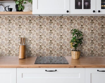 May include: A kitchen backsplash with a beige and brown geometric pattern. The backsplash is made of small, irregular shapes that resemble stones. A black electric stovetop is in the foreground.