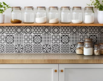 May include: A kitchen backsplash with black and white patterned tiles. A wooden shelf with glass jars filled with various ingredients sits above the tiles.
