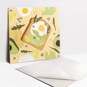 May include: A yellow background with a repeating pattern of avocado toast with a fried egg, avocado slices, lemon wedges, and sprigs of arugula.
