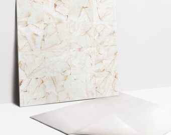 May include: A white marble tile sheet with a subtle shimmer and a light brown veining pattern. The sheet is made up of 25 individual tiles.