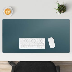 May include: A blue desk mat with a white keyboard and white mouse. The desk mat is on a white surface.