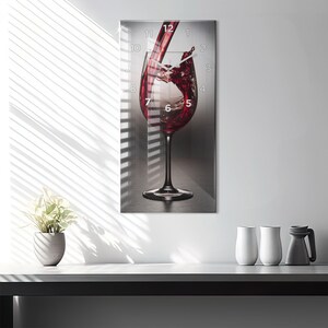May include: A glass clock with a red wine glass design. The clock face is visible with the numbers 1 through 12. The wine glass is filled with red wine and the wine is pouring out of the glass.