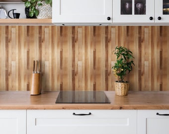 May include: A kitchen with white cabinets, a wooden countertop, and a backsplash made of vertical wooden planks. A small potted plant sits on the countertop, and a knife block is visible. The kitchen has a modern, clean design.