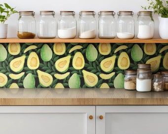 May include: A kitchen scene featuring a wooden shelf with glass jars and a countertop with white cabinets. The backsplash showcases a repeating pattern of green avocados and leaves on a black background. The jars contain various ingredients.