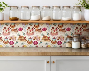 May include: A kitchen countertop with a white backsplash featuring a repeating pattern of colorful pastries, donuts, and candy. There are glass jars on a wooden shelf above the backsplash.