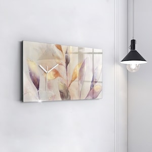 May include: A rectangular glass clock with a watercolour design of leaves in shades of purple, orange, and yellow. The clock has white hands and a white face.