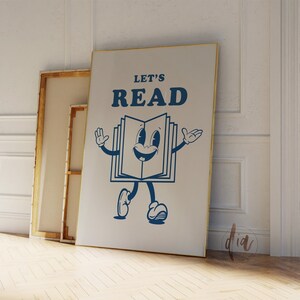 May include: A white canvas print with a blue illustration of a book character with the text "Let's Read" on a white background.