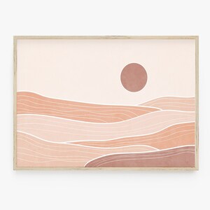 Peut inclure: Impression d'art abstrait représentant un paysage rose et pêche avec un grand soleil rond dans le ciel. Le paysage est composé de lignes ondulées et le soleil est un cercle plein.