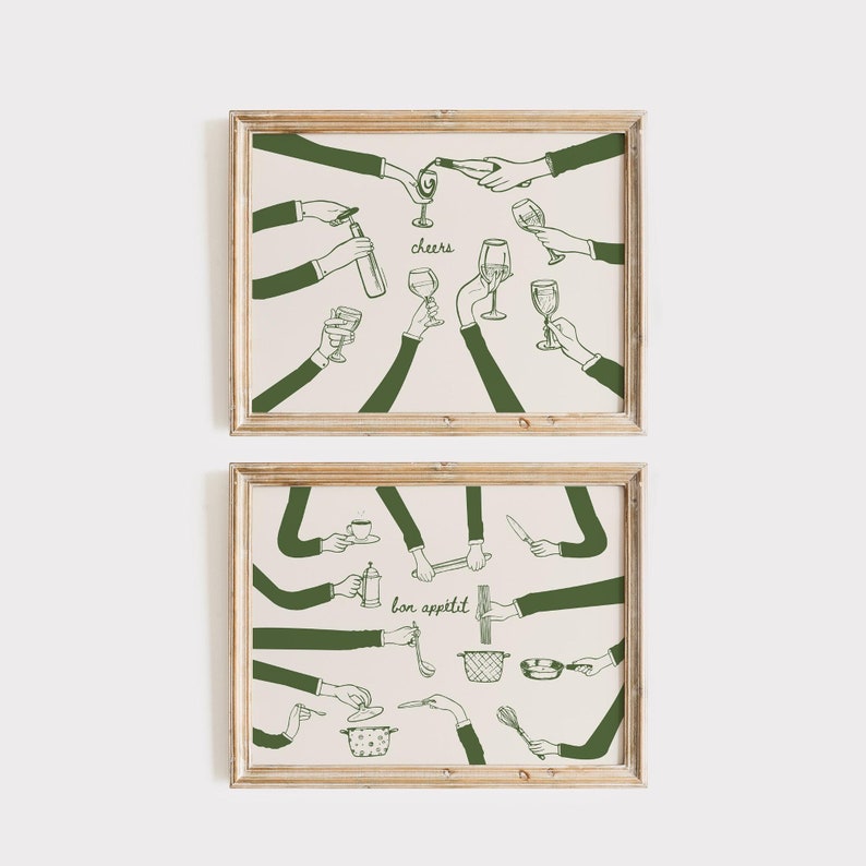 May include: Two framed art prints. The top print features hands toasting with wine glasses and bottles, with the word "cheers". The bottom print shows hands using kitchen utensils, with the words "bon app&eacute;tit". The illustrations are in green on a cream background.