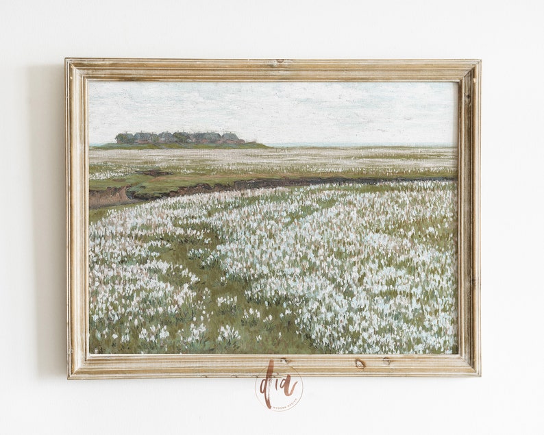 May include: A framed painting depicting a landscape with a field of white flowers in the foreground, a small group of houses in the distance, and a cloudy sky.