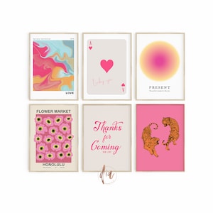 May include: Six pink and white framed prints with various designs. The prints include a pink and blue abstract design, a playing card with a heart, a gradient circle, a pink floral pattern, a pink background with the text "Thanks for Coming", and two orange tigers on a pink background.