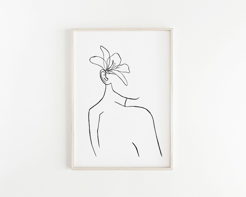 May include: A black and white line drawing of a person with a flower on their head. The drawing is simple and elegant, and would look great in a modern home.