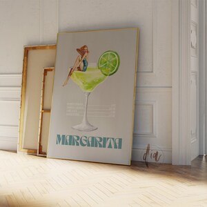 May include: A vintage-style poster with a watercolor illustration of a margarita cocktail. A woman in a swimsuit sits on the rim of the glass. The poster has the word "Margarita" in a retro font.