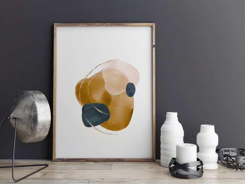May include: A framed abstract print with a watercolour design featuring overlapping shapes in shades of mustard yellow, peach, and teal.