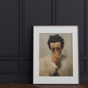 May include: A framed black and white portrait of a man with dark hair, wearing a white shirt, with his hand covering his mouth and nose.