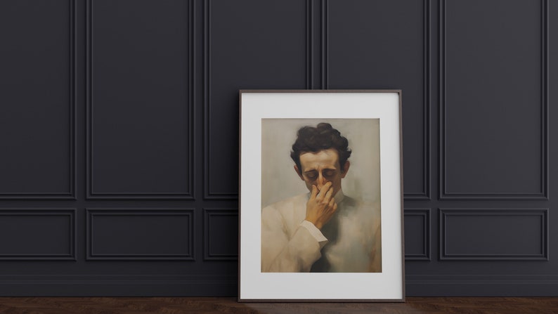 May include: A framed black and white portrait of a man with dark hair, wearing a white shirt, with his hand covering his mouth and nose.