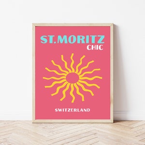 May include: A pink and blue poster with the text "ST. MORITZ CHIC SWITZERLAND". A yellow sun with wavy rays is in the center of the poster.