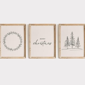 May include: Set of three printable wall art prints featuring a wreath, the text "Merry Christmas", and a line drawing of three pine trees.