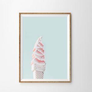 May include: A pink and white ice cream cone sign with the text "Eat It All" against a light blue background.