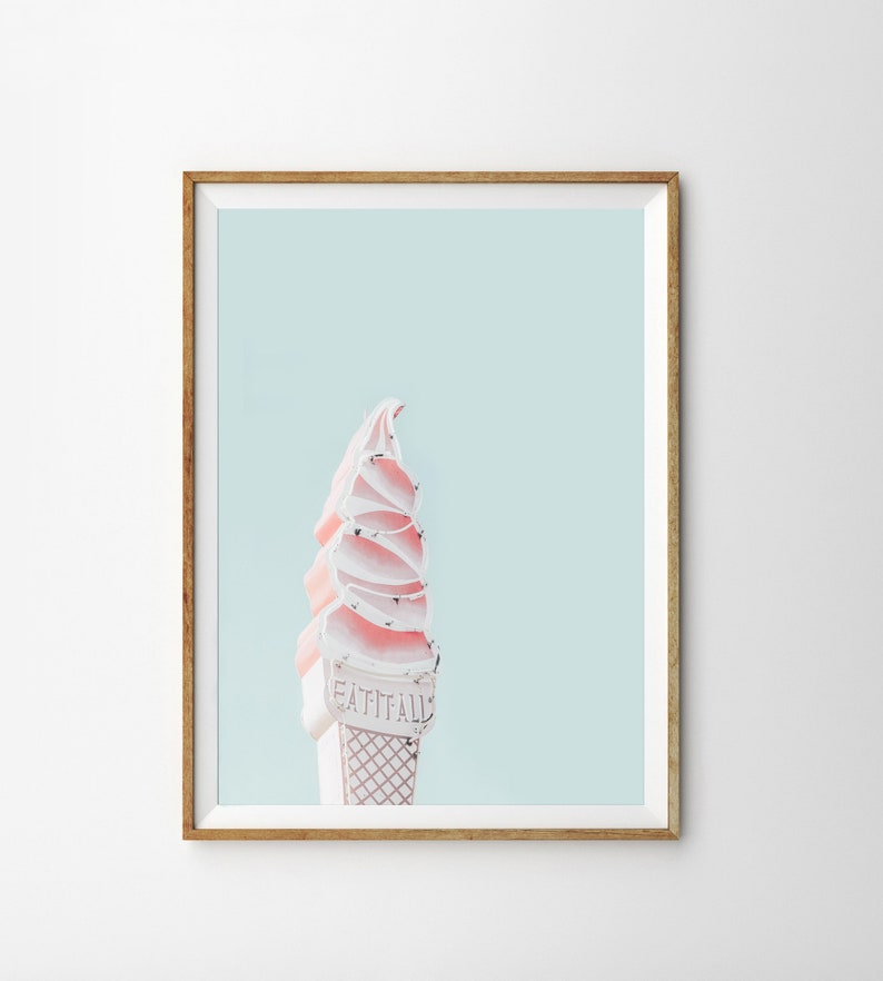 May include: A pink and white ice cream cone sign with the text "Eat It All" against a light blue background.