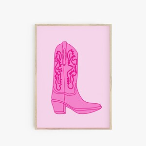 May include: A pink cowboy boot with a detailed design on the shaft, outlined in a darker pink, against a light pink background.