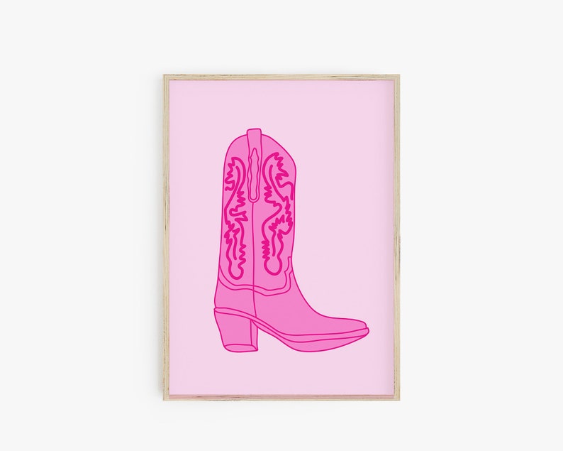 May include: A pink cowboy boot with a detailed design on the shaft, outlined in a darker pink, against a light pink background.