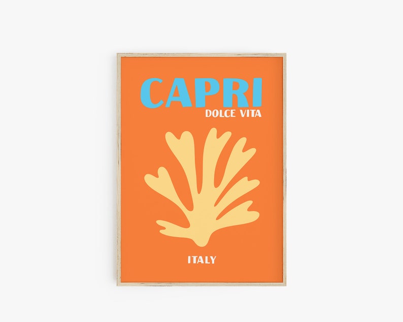 May include: A framed print with an orange background and a yellow stylized coral design. The text "CAPRI" in blue and "DOLCE VITA" in white is at the top of the print. The text "ITALY" is at the bottom of the print.
