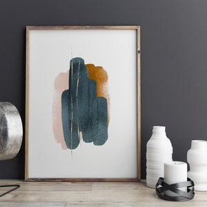 May include: Abstract art print with a teal, pink, and gold design in a wooden frame. The print is hanging on a dark gray wall.
