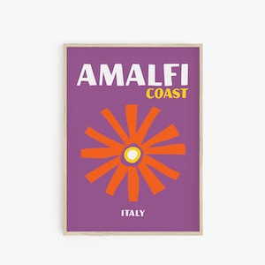 May include: A purple poster with the text "Amalfi Coast, Italy" in white and yellow. A stylized orange flower with a yellow centre is in the middle of the poster.