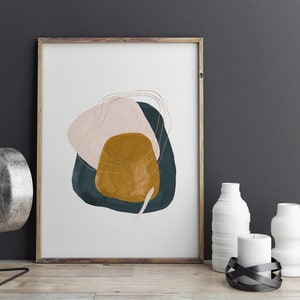 May include: Abstract art print featuring a pink, teal and gold design. The print is framed in a light wood frame.