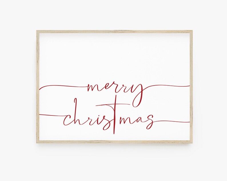 Op de afbeelding: Een ingelijst afdruk met de tekst "merry christmas" in een cursief lettertype in rood op een witte achtergrond.