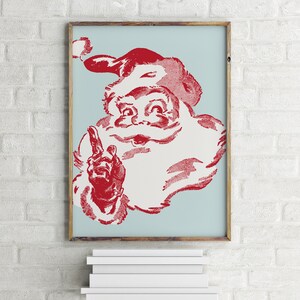 May include: A vintage-style illustration of Santa Claus with a red beard and hat, against a light blue background. He is pointing with his right hand and smiling.