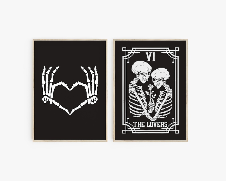 May include: Two black and white prints with a skeleton theme. The first print shows two skeleton hands making a heart shape. The second print shows a tarot card with the number VI and the words "The Lovers" with two skeletons embracing.