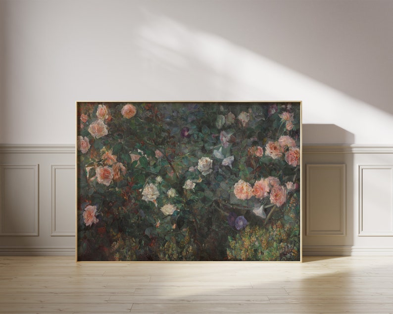 May include: A framed floral print featuring a lush garden scene. The artwork showcases a variety of roses in shades of pink and white, set against a backdrop of green foliage. The frame is a warm gold color, adding to the classic aesthetic.