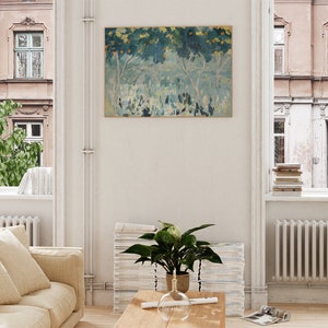 May include: A painting of a landscape with trees and a blue sky. The trees are in the foreground and the sky is in the background. The painting is in a white frame and is hanging on a white wall.