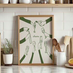 May include: A framed illustration of a group of people raising their glasses in a toast. The illustration is in green and white and features the word "cheers" in the centre.