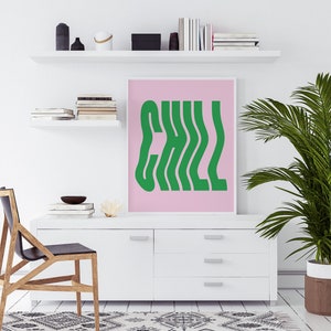 May include: A pink and green wall art print with the word "CHILL" in a wavy, retro font.