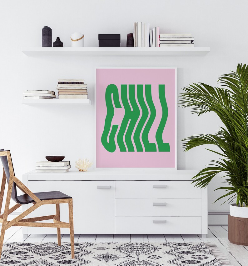 May include: A pink and green wall art print with the word "CHILL" in a wavy, retro font.