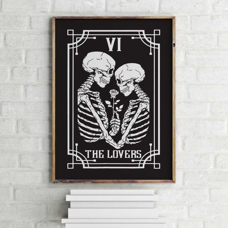 May include: Black and white illustration of two skeletons holding a rose, with the text "VI THE LOVERS" in a decorative frame.