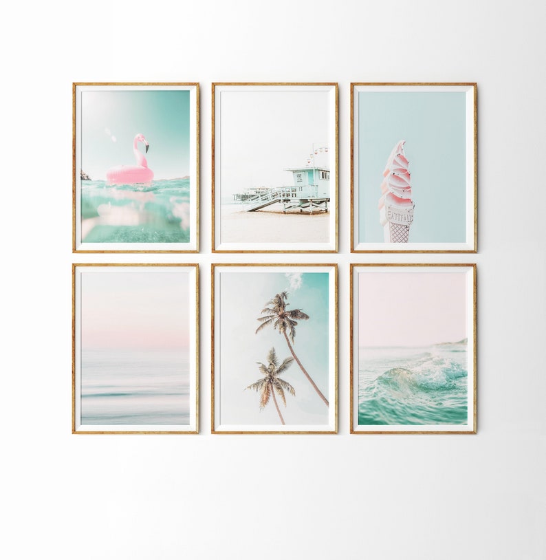 May include: A set of six framed prints with a beach theme. The prints feature a pink flamingo float, a beach house, an ice cream cone, a palm tree, and two ocean scenes.