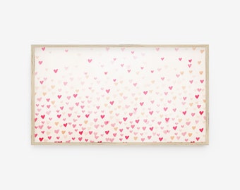 May include: A framed print featuring a pattern of small, watercolor hearts in shades of pink and red against a cream background. The hearts are scattered across the print, creating a visually appealing design. The frame is a light wood color.