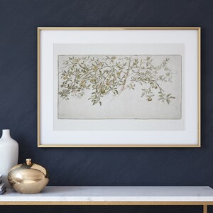 May include: A framed watercolor painting of a branch of a tree with green leaves and small yellow fruit. The painting is on a white background and is framed in a gold frame.