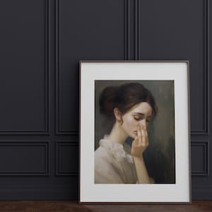 May include: A framed painting of a woman with brown hair, wearing a white blouse, looking down with her hand covering her face. The background is a muted green.