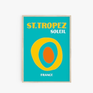 May include: A turquoise blue poster with a yellow sun graphic and the text "ST. TROPEZ SOLEIL FRANCE".
