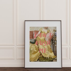May include: A framed print of a woman in a yellow dress sitting on a couch. The text "DON'T RUSH ME" is superimposed on the image in pink.