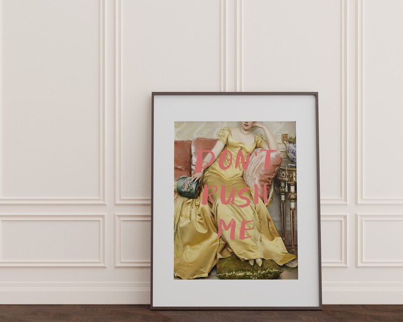 May include: A framed print of a woman in a yellow dress sitting on a couch. The text "DON'T RUSH ME" is superimposed on the image in pink.