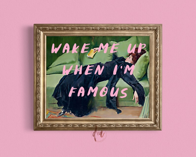 May include: A framed painting of a woman lying on a green couch with the text "Wake me up when I'm famous" written in pink.