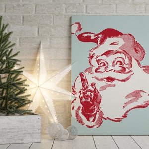 May include: A vintage-style Christmas print featuring a red and white Santa Claus with a blue background. Santa is smiling and pointing with his right index finger.