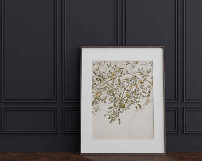 May include: A framed watercolor painting of a branch of a tree with green leaves and yellow fruit. The background is a light beige color.