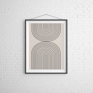 May include: A framed print with a minimalist geometric design featuring black arches on a light beige background.